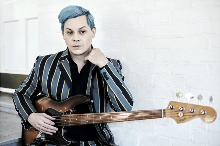 A man holding a guitar.