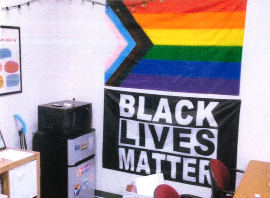 a black lives matter flag and gay pride flag