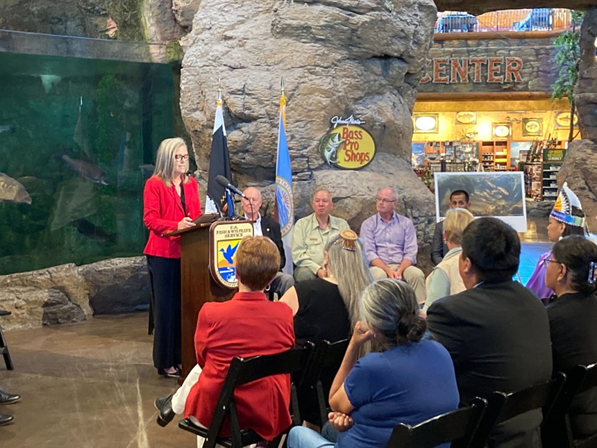 A woman speaking at a store.