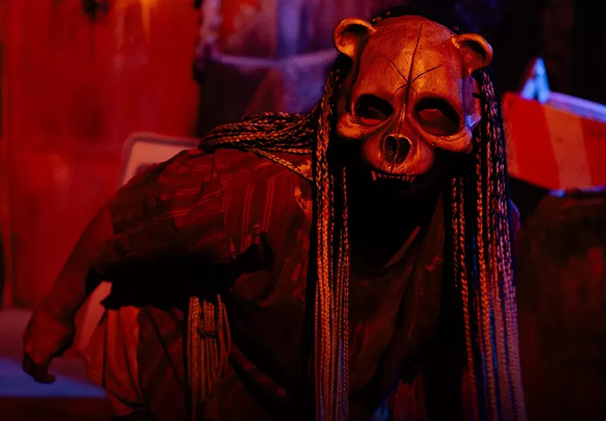 A haunted house actor in costume.