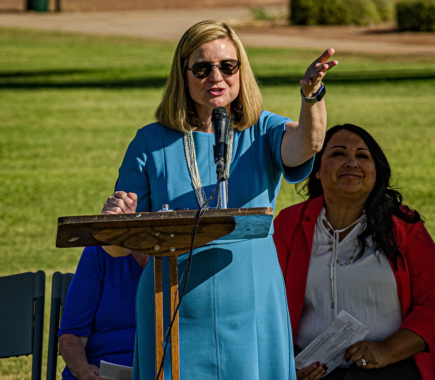 Kate Gallego speaks and gestures at a podium outside