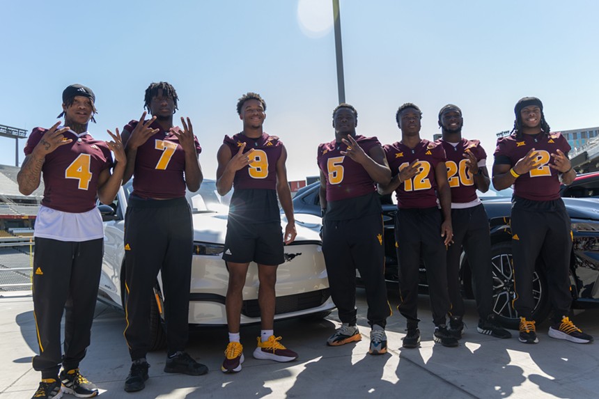 ASU football players Myles Rowser, Chamon Metayer, Montana Warren, Jeff Clark, Javan Robinson and Kyson Brown pose in front of their new cars.