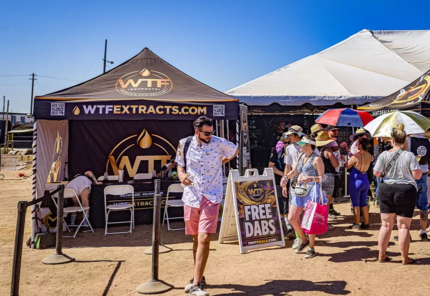 people wait outside a Mint Dispensary tent