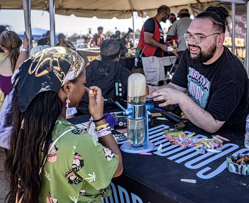 An Errl Cup attendee prepares to take a complimentary hit from a gravity bong.
