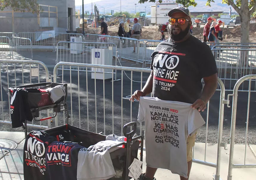 A man sells merchandise outside a Donald Trump rally in Prescott Valley.