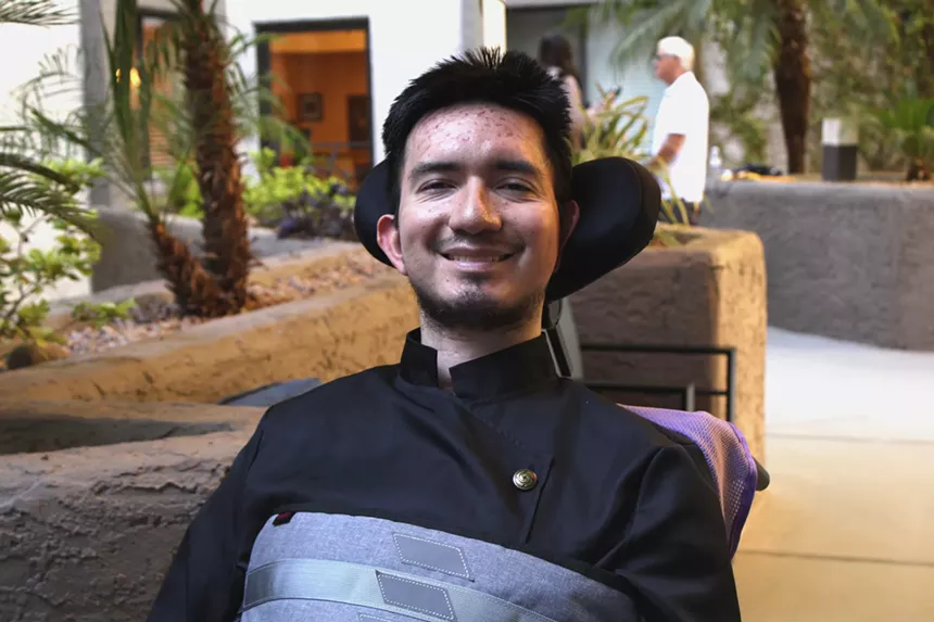 a man in a wheelchair smiling