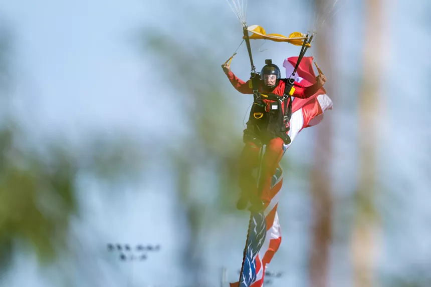 a skydiver comes in for a landing