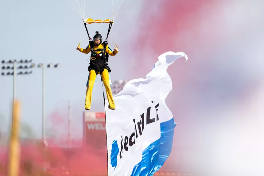 a skydiver braces for a landing