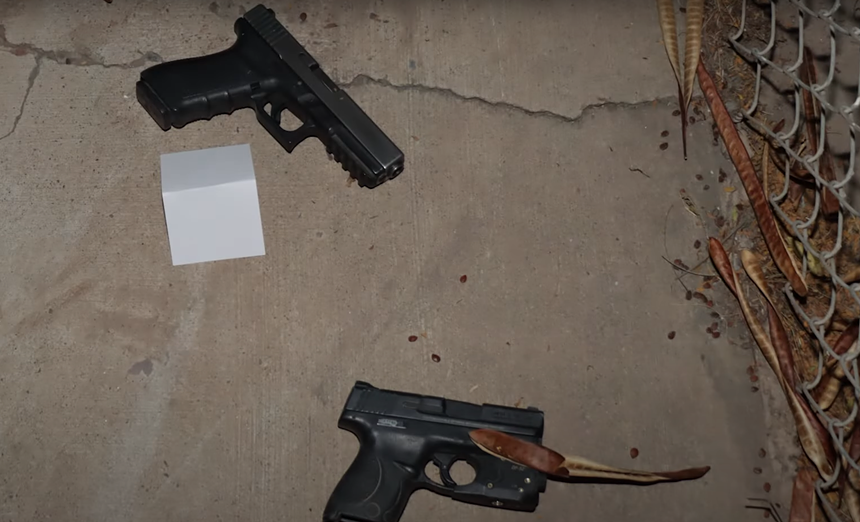 two handguns on the ground