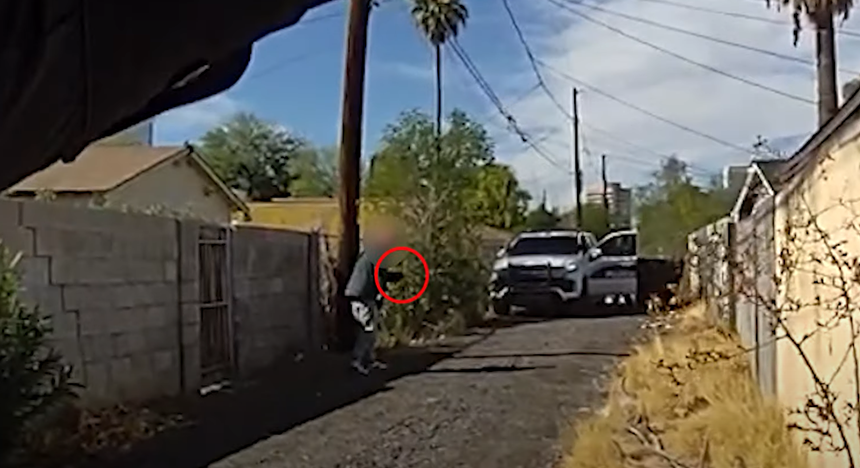 body cam footage showing a blurry man in an alley with one arm raised