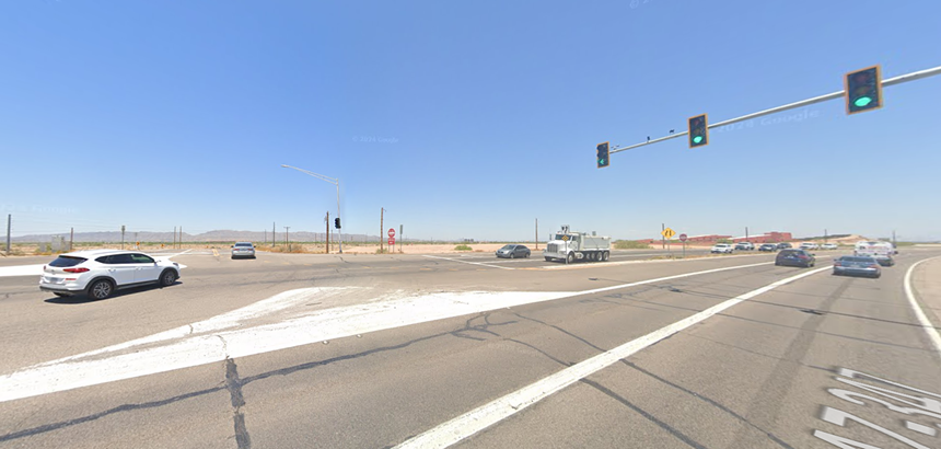 cars going through a rural intersection