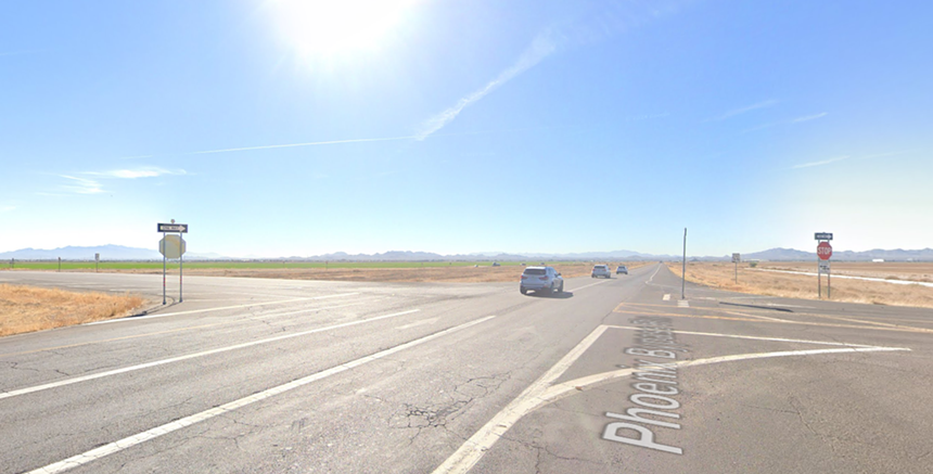 cars going through a rural intersection