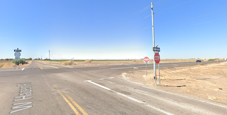cars going through a rural intersection