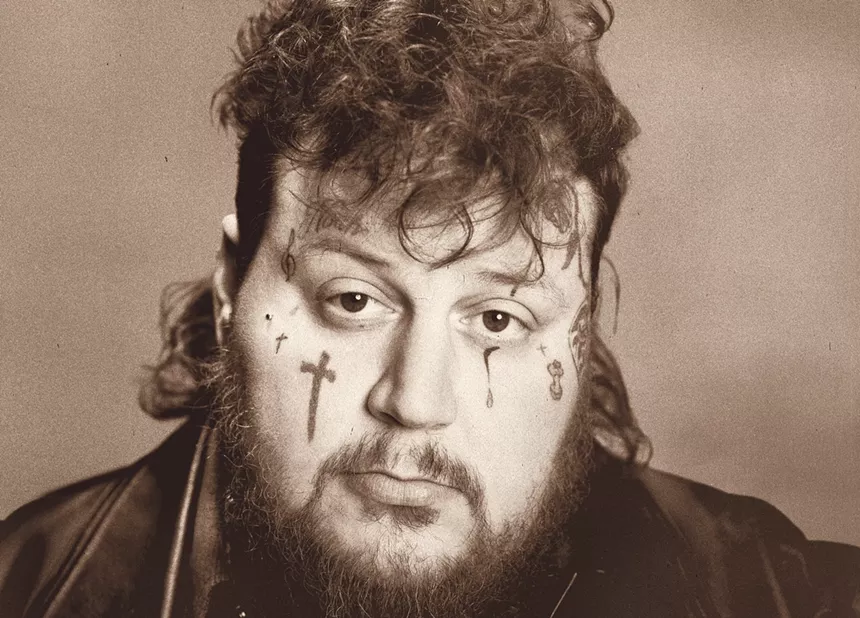 A young man with face tattoos.