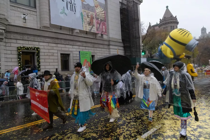 Indigenous dancers enduring a rainstorm.