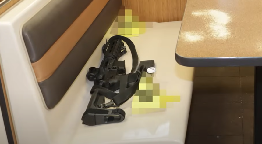 an assault rifle on a fast food restaurant seat