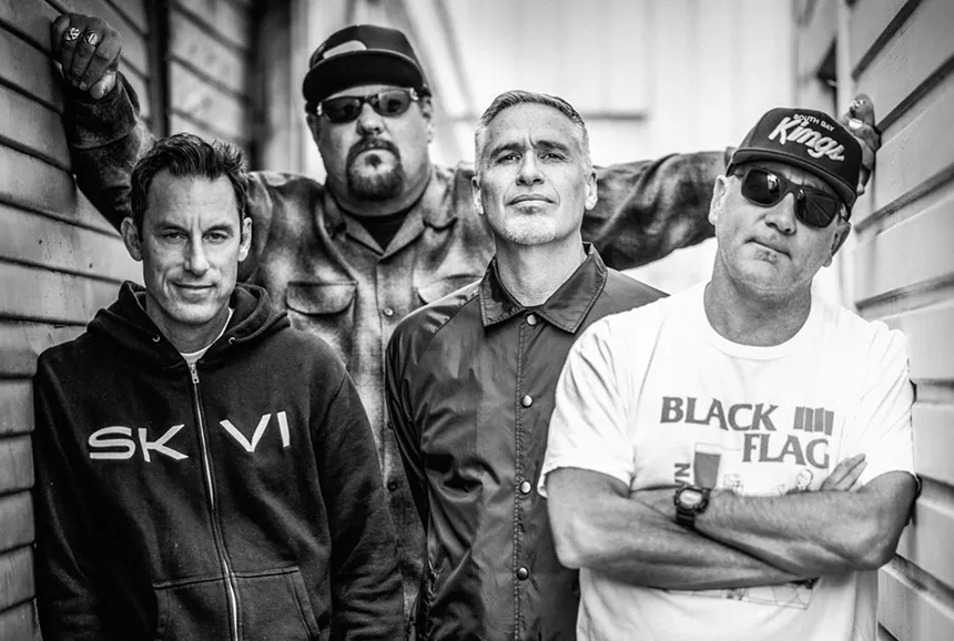 A black and white photo of men standing together.