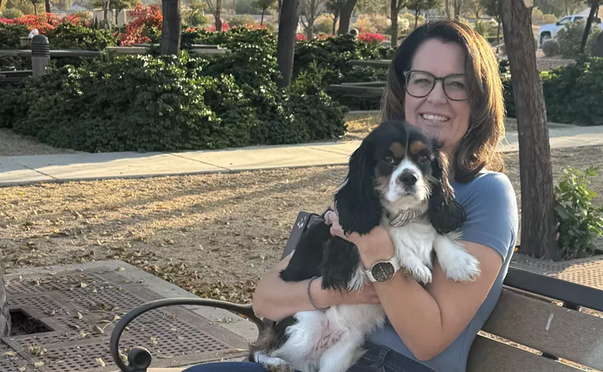 a woman and a cavalier king charles spaniel