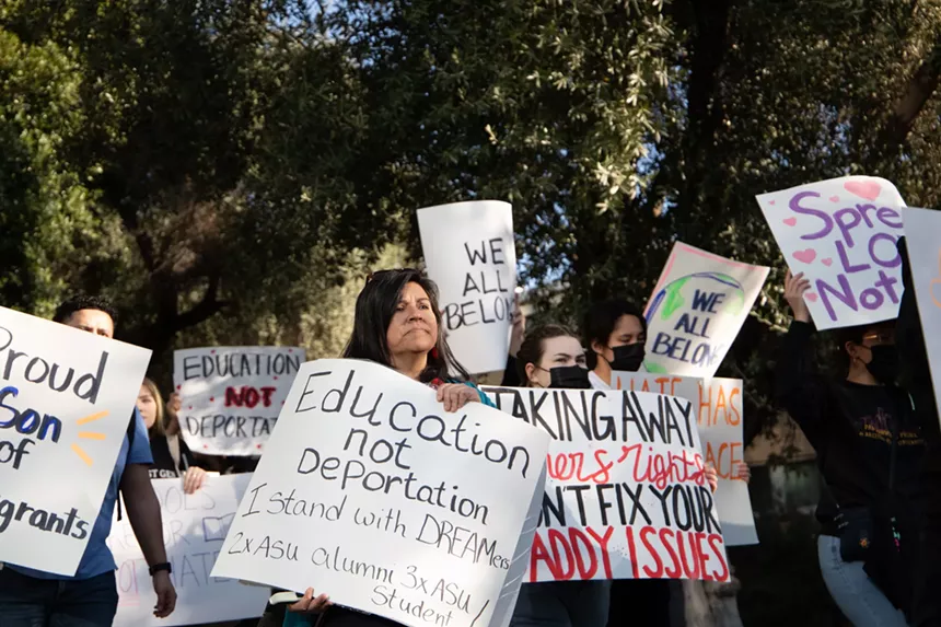 protesters holding pro-immigration signs