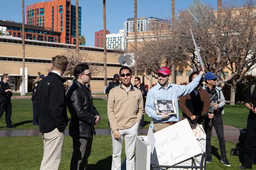 people hold signs at a protest