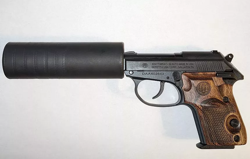 a gun with a suppressor attached