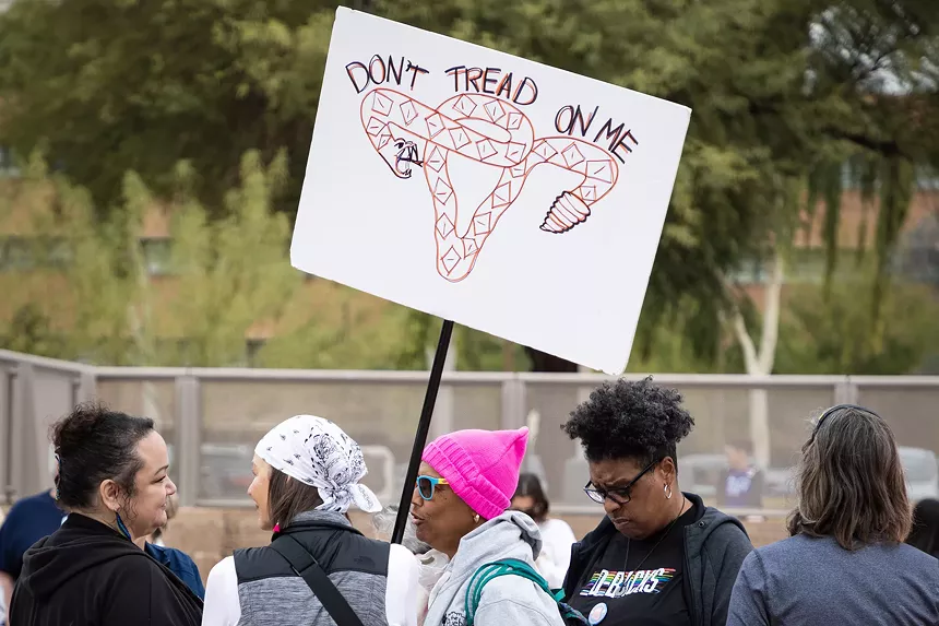 a "don't tread on me" sign in which a snake makes the shape of a uterus