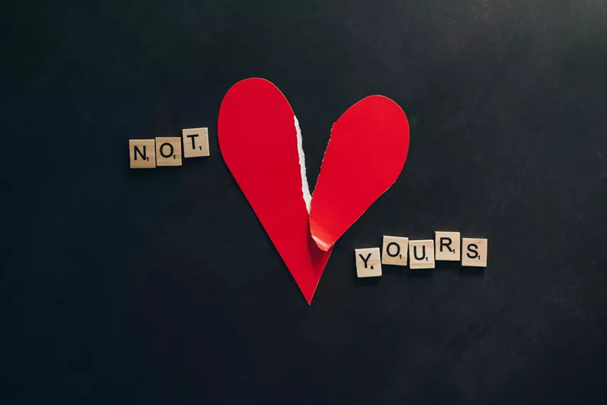 Scrabble tiles and a paper heart
