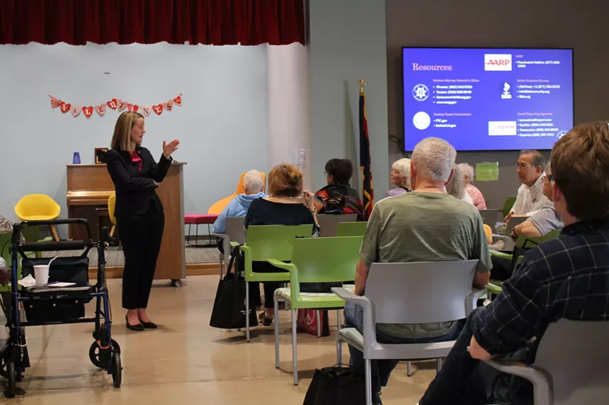 A woman speaking in front of an audience.