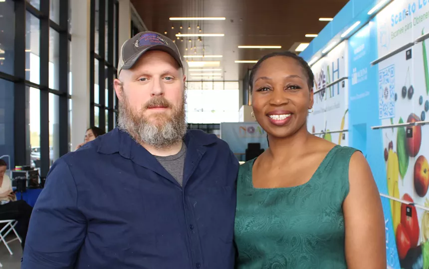 a man and woman look at the camera