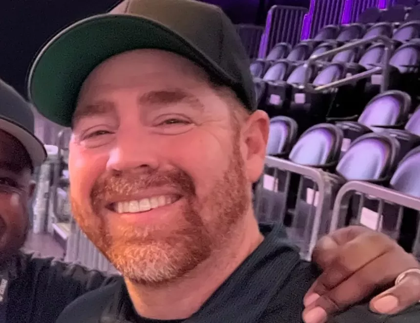 a man smiling in an arena