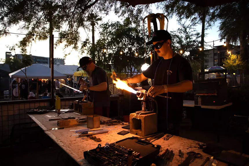 two men work at glass blowing