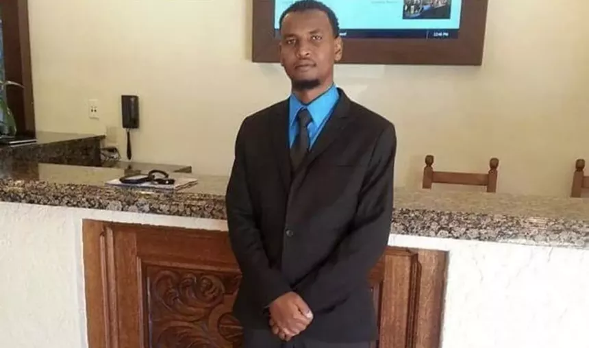 a man stands in a suit