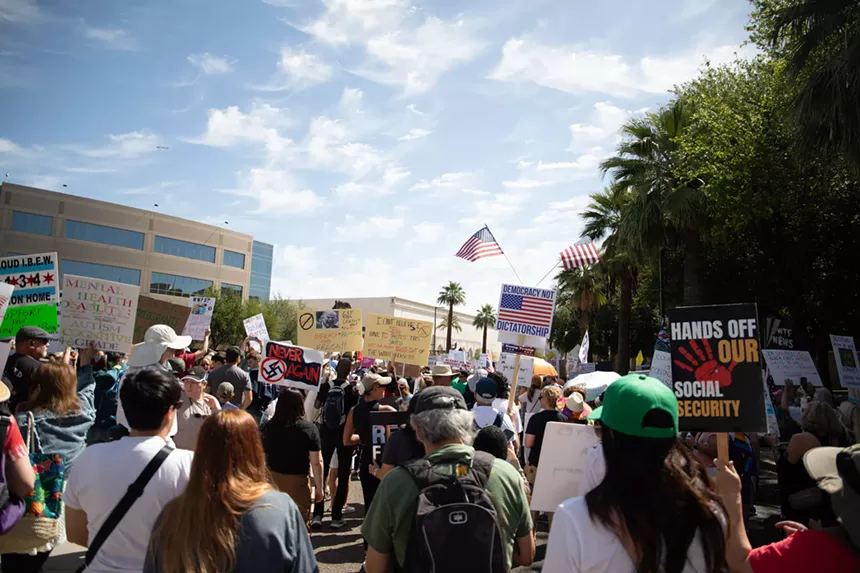 protesters march with signs