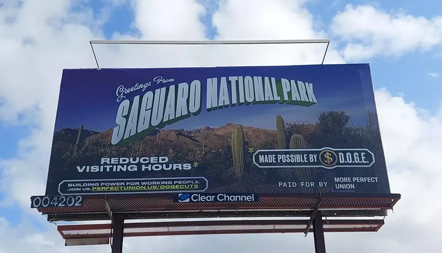 a billboard that says "greetings from saguaro national park, reduced visiting hours, made possible by DOGE"