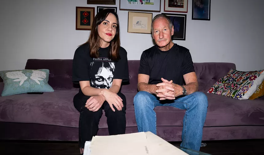 a man and woman sit on a couch