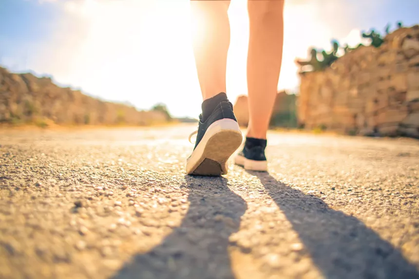 A person walking on a hiking trail.