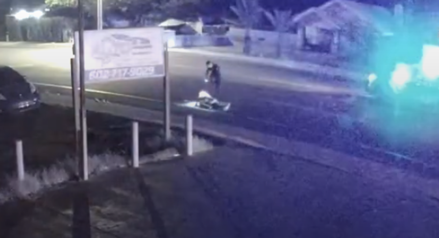 in security footage, a man stands over another man on the ground