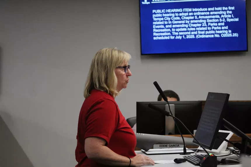 a woman speaks at a city council meeting