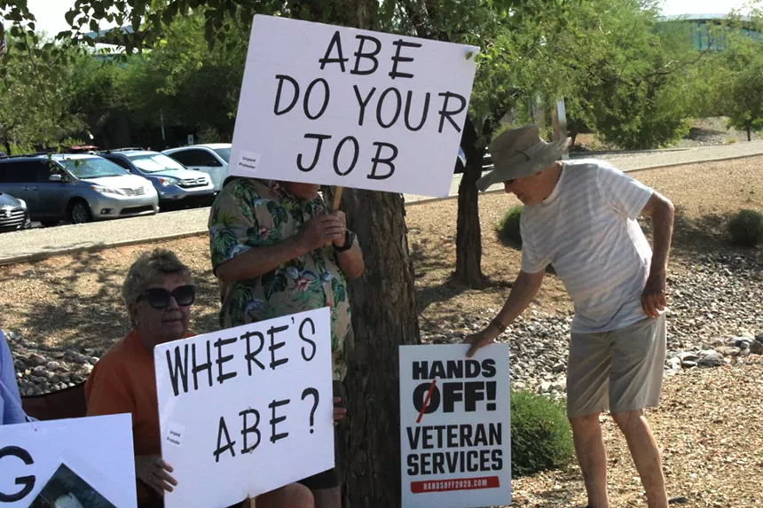 protesters holding signs that say "abe do your job" and "where's abe?"
