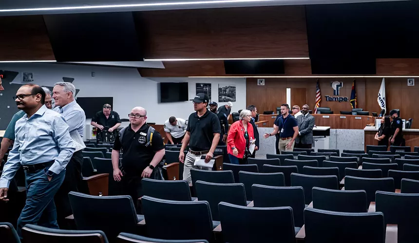 Attendees evacuate the Tempe Municipal Building.