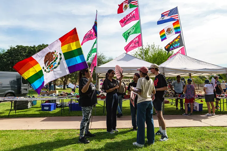 A hybrid Mexican/rainbow flag flutters in a welcome breeze near hybrid Mexican/U.S. and El Salvadoran/U.S. flags, and others representing women’s bodily autonomy.