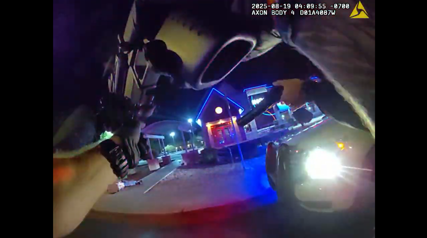 body-cam footage shows arms of a police officer pointing a weapon at someone on the ground at night