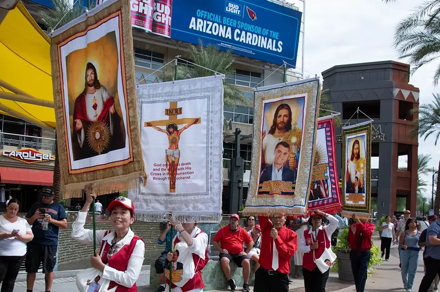 people carrying banngers with jesus and charlie kirk on them