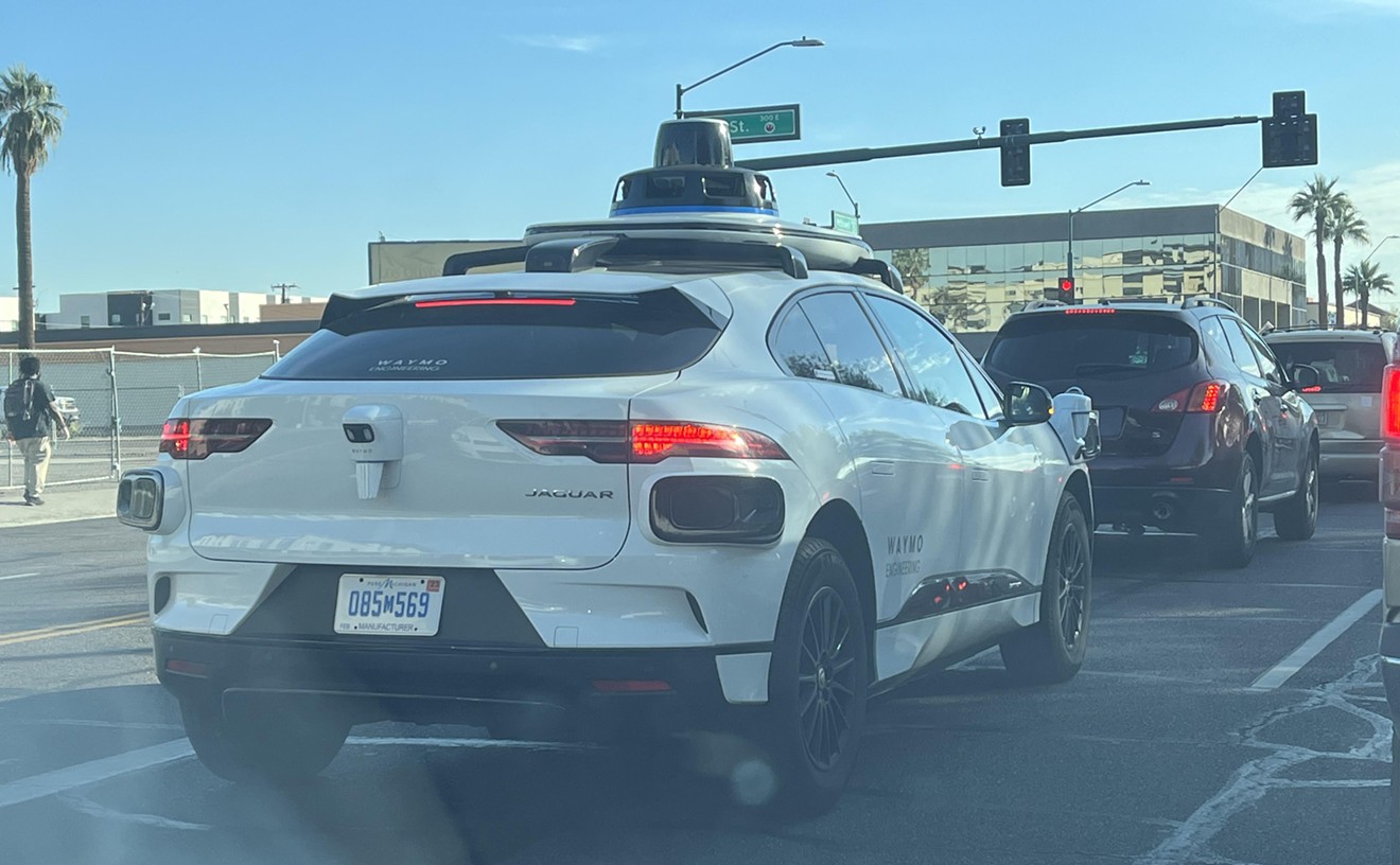 A Waymo vehicle drives down McDowell Road in central Phoenix.