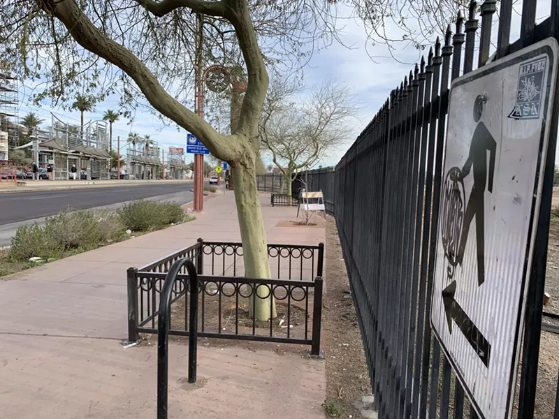 Image: A pedestrian crosswalk sign near the Indian School light rail train stop.