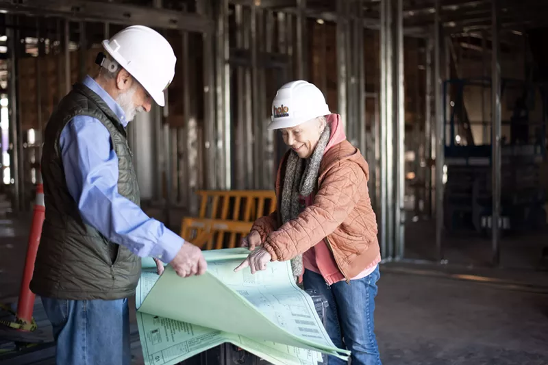Image: Murray Stein and Linda Bell review plans for Halo's new edibles kitchen under construction in Tucson.