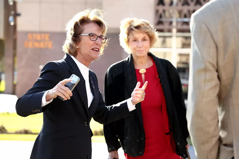 Image: State Senator Wendy Rogers (left) speaks with supporters outside the Arizona State Capitol building on the opening day of the 55th Legislature in Phoenix in January.