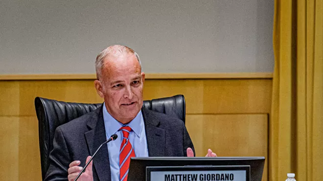 a man in a suit at a meeting