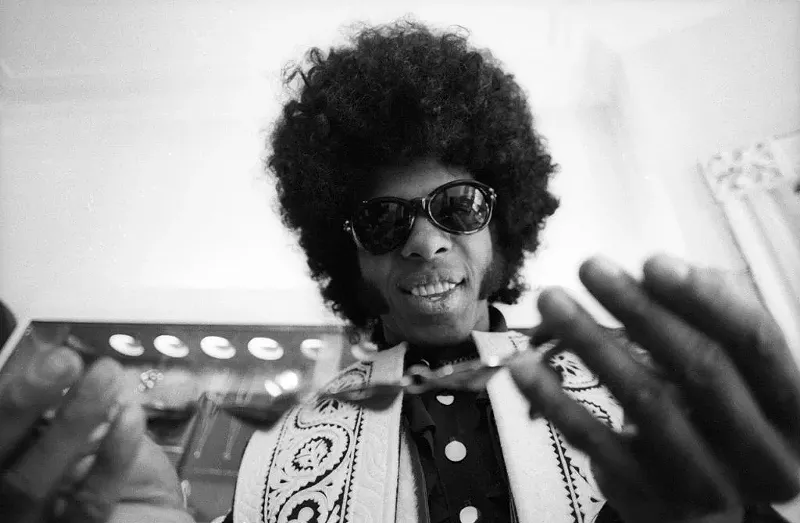 Image: Sly Stone of the psychedelic soul group Sly And The Family Stone tries on a necklace on March 9, 1969.