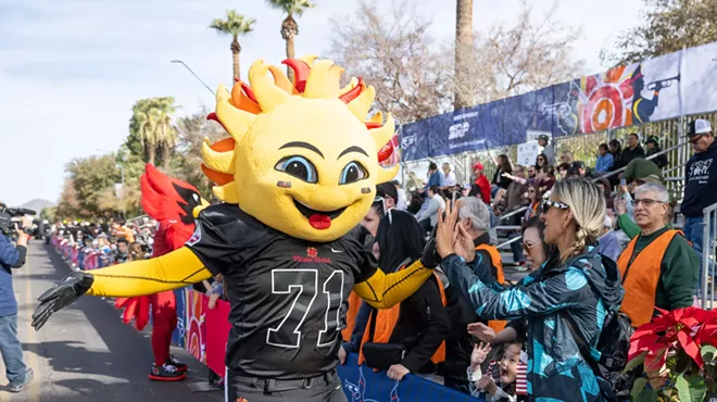A person in a costume interacting with the public.